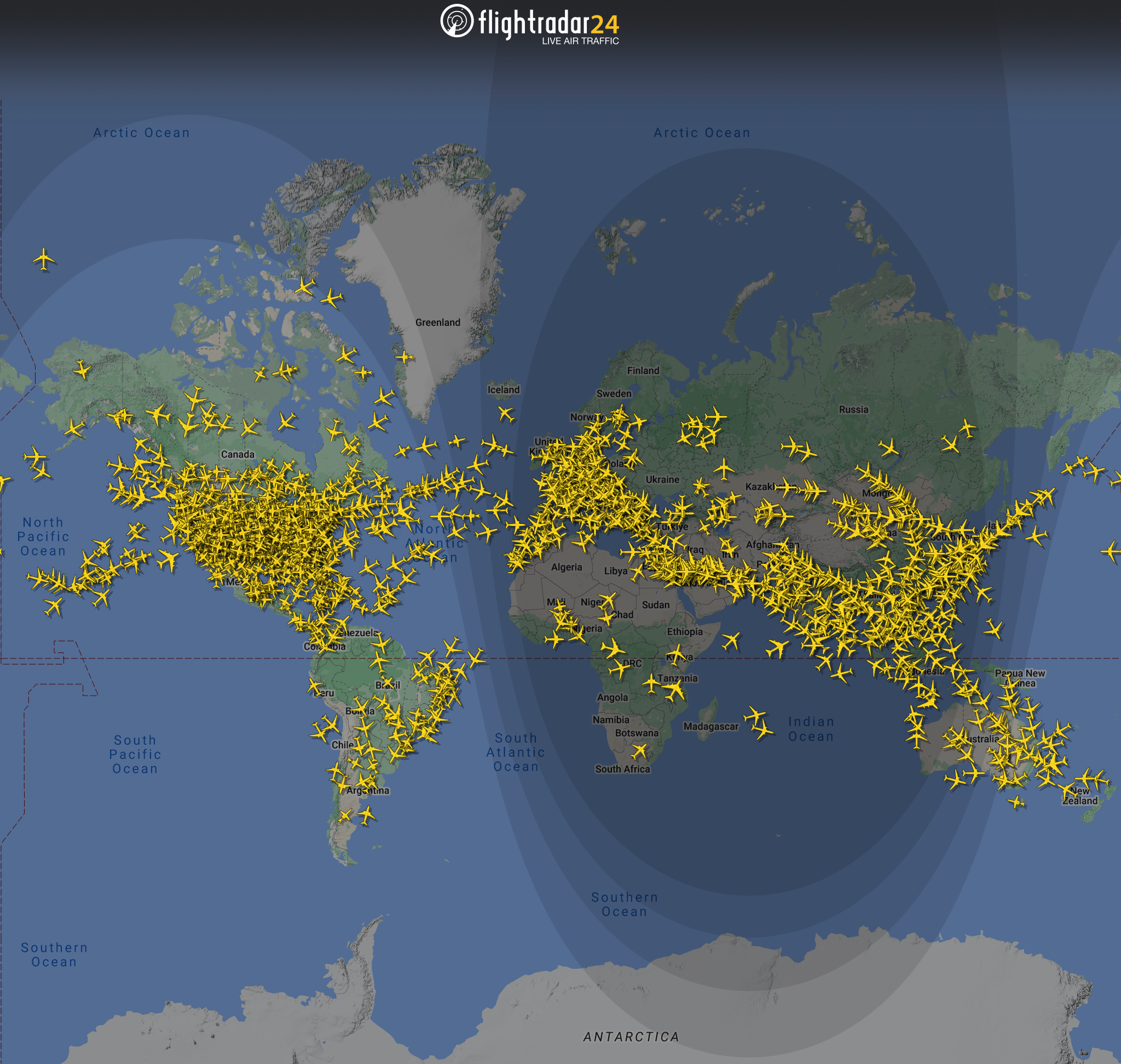 The image is a map from Flightradar24 showing live air traffic. It displays numerous yellow airplane icons scattered across various regions, indicating the locations of flights in real-time. The map covers a large portion of the world, including North and South America, Europe, Africa, and parts of Asia and Australia. The background is a dark blue, representing the oceans, with landmasses in green and gray.